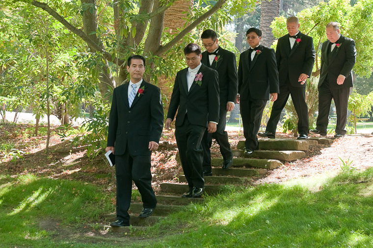 The pastor, Johnny, and his groomsmen walking to the front