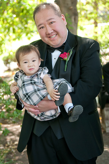 Groomsman holding his child